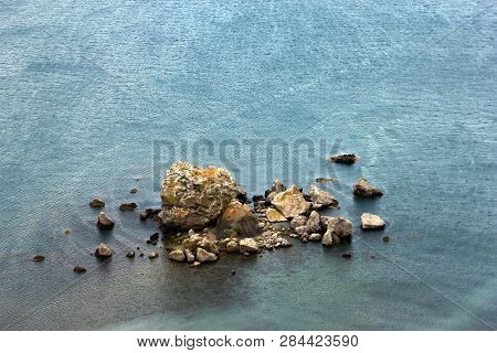 The Archipelago Of A Pile Of Stones Or Cliffed Coast In The Middle Of The Blue Sea-a Rocky Island In