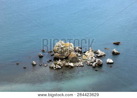 The Archipelago Of A Pile Of Stones Or Cliffed Coast In The Middle Of The Blue Sea-a Rocky Island In