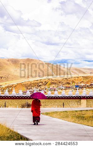 Tagong, China On 12th May 2015 - View On Tibetan Monk Walking With Umrella
