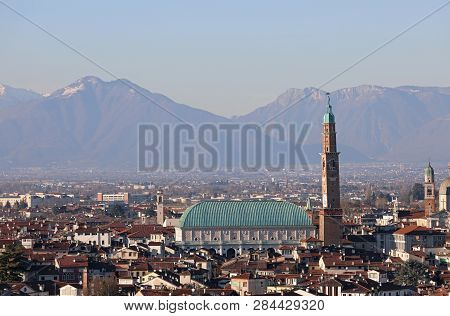 View Of Main Monument Of Vicenza City In Italy Called Palladian Basilica And Summano Mount In Backgr