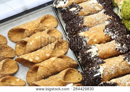 Empty Pastries Or With Cheese And Chocolate In The Pastry Called Cannoli Siciliani In Italian Langua