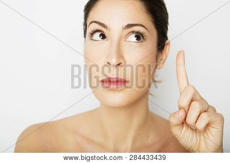 Fashion Photo Of A Beautiful Brunette Woman With Dark Short Hair Posing Over White Empty Background.
