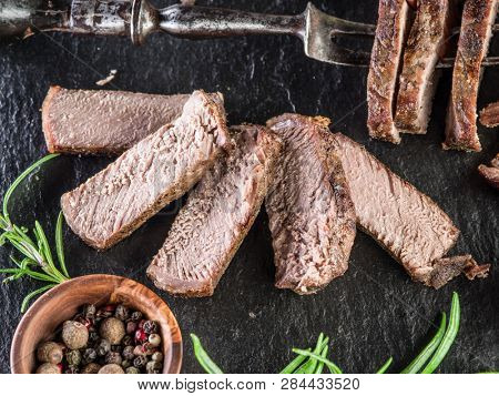 Steak Ribeye with spices on the graphite board.