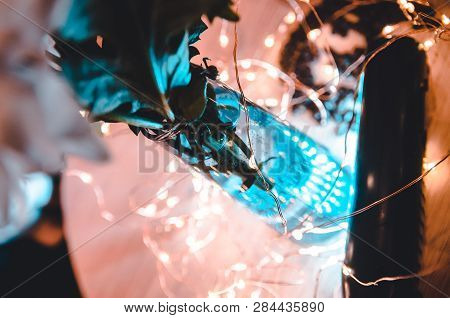 Lights Shining Through The Transperant Vase With Water And White Flowers. Top View On The Decoreted 