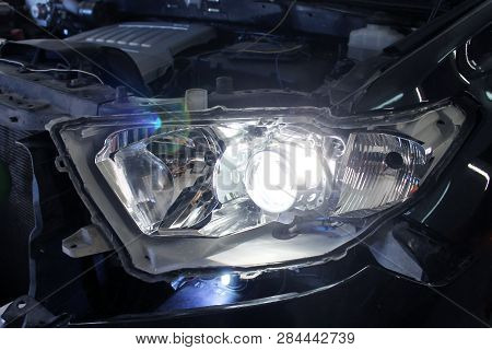 Macro View Of Modern Automobile In Autoservice With Auto Projector Lens. Mechanic Car Repair Service