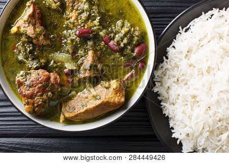 Authentic Ghormeh Sabzi Dish Of Lamb Stew Meat With Herbs And Beans Close-up In A Bowl And Rice. Hor