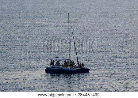 Small Pleasure Boat With Tourists On Blue Sea Water