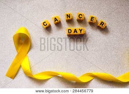 Golden Ribbon And Words Made Up Of Children's Plastic Beeches. Concept - A Symbol Of Childhood Cance