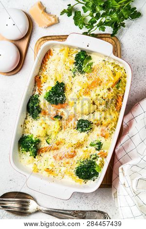 Casserole From Pasta And Vegetables - Carrot, Broccoli And Cauliflower In Cream Sauce With Parmesan.