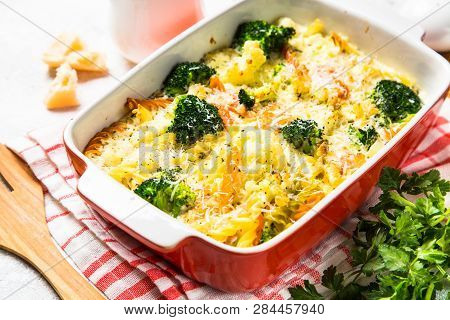 Casserole From Pasta And Vegetables - Carrot, Broccoli And Cauliflower In Cream Sauce With Parmesan.