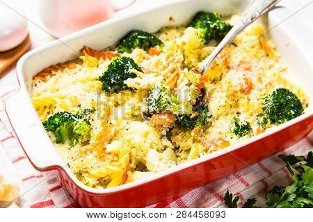 Casserole From Pasta And Vegetables - Carrot, Broccoli And Cauliflower In Cream Sauce With Parmesan.