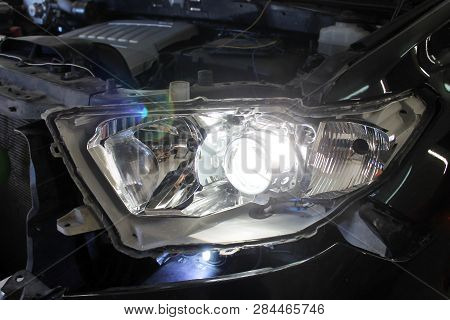 Macro View Of Modern Automobile In Autoservice With Auto Projector Lens. Mechanic Car Repair Service