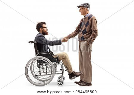 Full length shot of a man in a wheelchair shaking hands with a senior man isolated on white background
