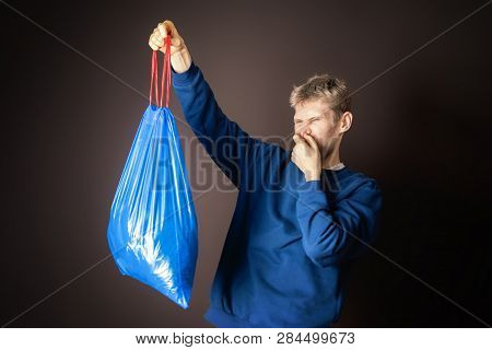 Attractive Male Hold Smelly Garbage Bag Isolated. Take Out Trash Concept