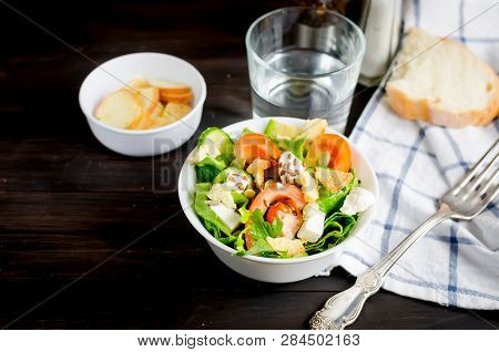 Fresh Light Green Salad With Cucumber, Lettuce, Avocado, Tomatoes, Cheeseand Sseeds And Glass Water 