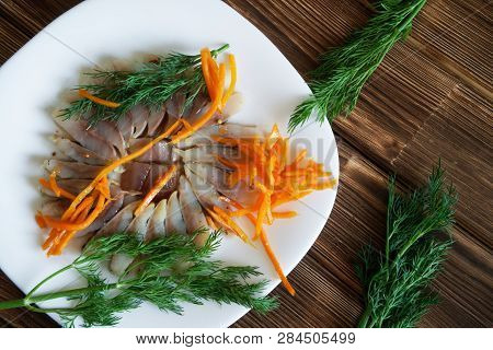 Sliced Scandinavian Herring Fillet With Spices, Dill And Pickled Carrots In A White Plate. Table Set