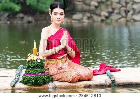 Portrait Young Woman Wearing Traditional Thai Red And Purple And Gold Jewelry With Krathong Flower O