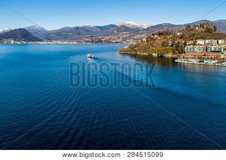 Landscape Of Lake Maggiore With Ferry That Crosses The Lake In Lavenomombello, Province Of Varese, I