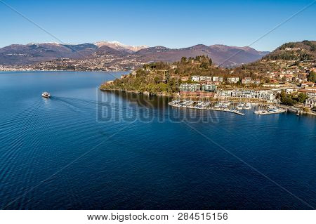 Landscape Of Lake Maggiore With Ferry That Crosses The Lake In Lavenomombello, Province Of Varese, I