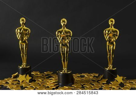 Xalapa, Veracruz, Mexico- February 14, 2019: Plastic Oscar Awards And Golden Stars Confetti Against 