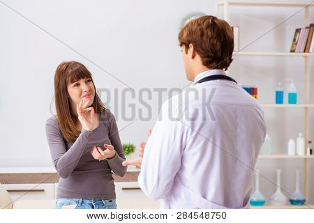 Deaf-mute female patient visiting young male doctor