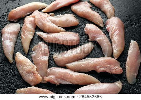 Raw Chicken Breast Mini Fillets In Rastic Cast Iron Skillet, Frying Pan With Herbs And Sea Salt