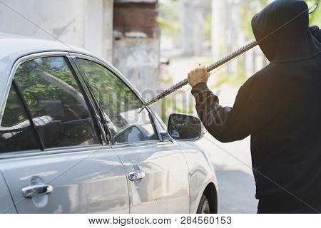 Side View Of Car Thief In Action