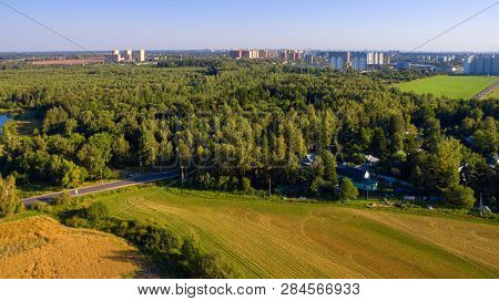 Top View Of Agricultural Field, Forest And Residential Area In The Distance