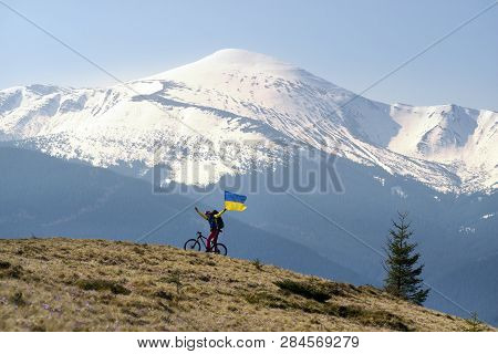 Lone Rider Among Fabulous Fantastic Snow Peaks Of The Ukrainian Carpathians Meets The Blossoming Spr