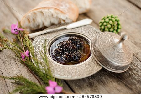 Delicious Composition Of The Cones Jam In The Silver Plate With A Cap, Tree Branch And Bread Near It