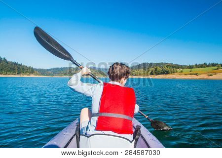 Sportive, Young Actice Woman Kayaking On Lake Lokve, In Gorski Kotar, Croatia. Adventurous Experienc