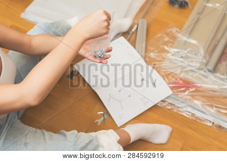 Instruction For Furniture Assembling In The Female Hands For Self Assembly.