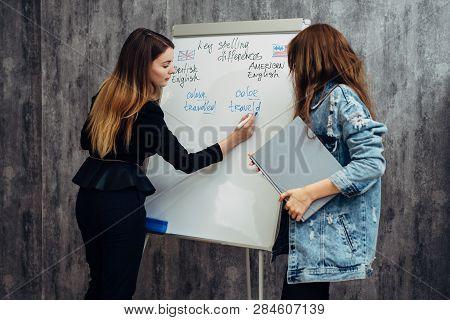English Language School. Two Female Students Talking In Classroom.