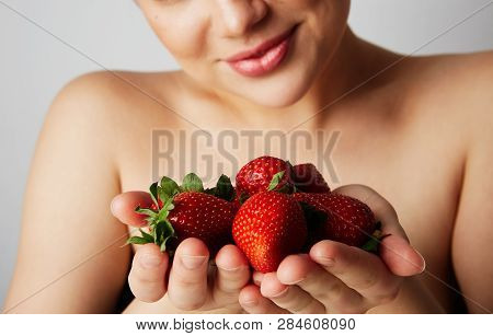 Pretty Happy Smiling Woman With Many Strawberry Over Colorful White Background.