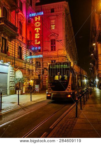 Turin, Italy - January 1, 2019. Hotel And Ristorante Neon Signboard In An Italian Street At Night Cr