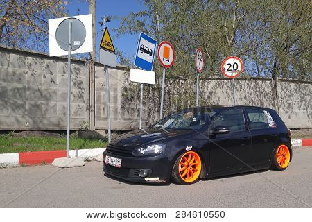 Moscow. Autumn 2018. Black Volkswagen Golf Mk 6 Tuned By Air Suspension.  Low Car With Wide Orange W
