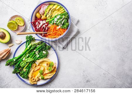 Vegan Lunch Concept. Rainbow Vegetable Salad And Broccolini With Hummus, Top View.