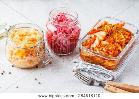 Korean Kimchi Cabbage, Beet Sauerkraut And Sauerkraut In Glass Jars, White Background. Probiotics Fo