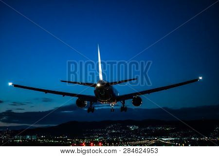 Jet Plane Landing Scene To The Airport At Dusk.