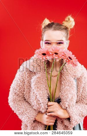 Blonde Woman With Nice Hairstyle Smelling Nice Flowers