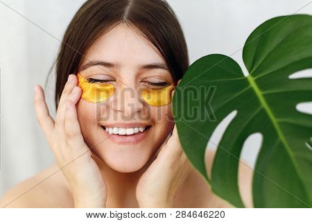 Happy Girl With Natural Skin And Lifting Anti-wrinkle Collagen Patches Under Eyes. Beauty Cosmetics.
