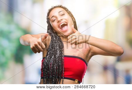Young braided hair african american with pigmentation blemish birth mark over isolated background approving doing positive gesture with hand, thumbs up smiling and happy for success
