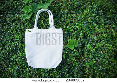 White Tote Canvas Fabric Eco Bag Cloth Shopping Sack On Green Leaf Nature Background / Zero Waste Us