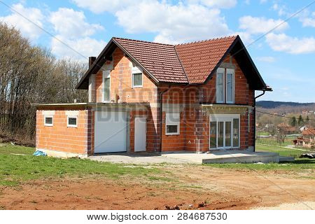 Unfinished Under Construction Small Suburban Red Brick Family House With Attached Garage Surrounded 