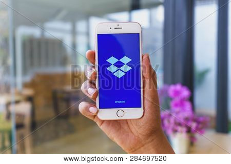 Chiang Mai, Thailand - Mar 02,2018: Man Holding Apple Iphone 6s Rose Gold With Dropbox On Screen. Dr