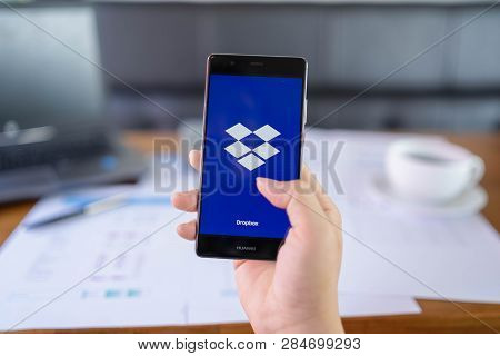 Chiang Mai, Thailand - May 05,2018: Man Holding Huawei With Dropbox On Screen. Dropbox Is A Service 