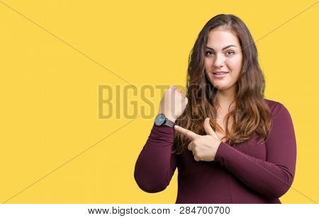 Beautiful and attractive plus size young woman wearing a dress over isolated background In hurry pointing to watch time, impatience, upset and angry for deadline delay