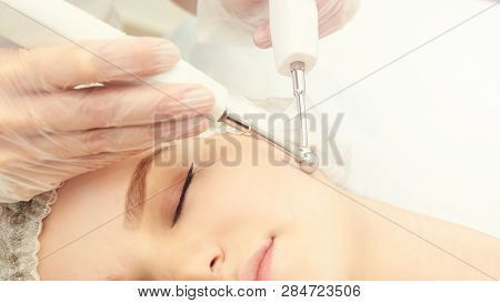 Facial Micro Current Cosmetology Procedure. Beauty Technology Treatment. Woman Face Therapy