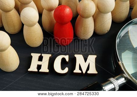 Human Capital Management Hcm Concept. Figurines And Magnifying Glass.