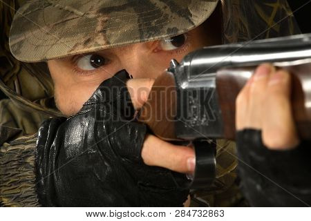 Eyes Of The Shooter Aiming With A Shotgun, Closeup